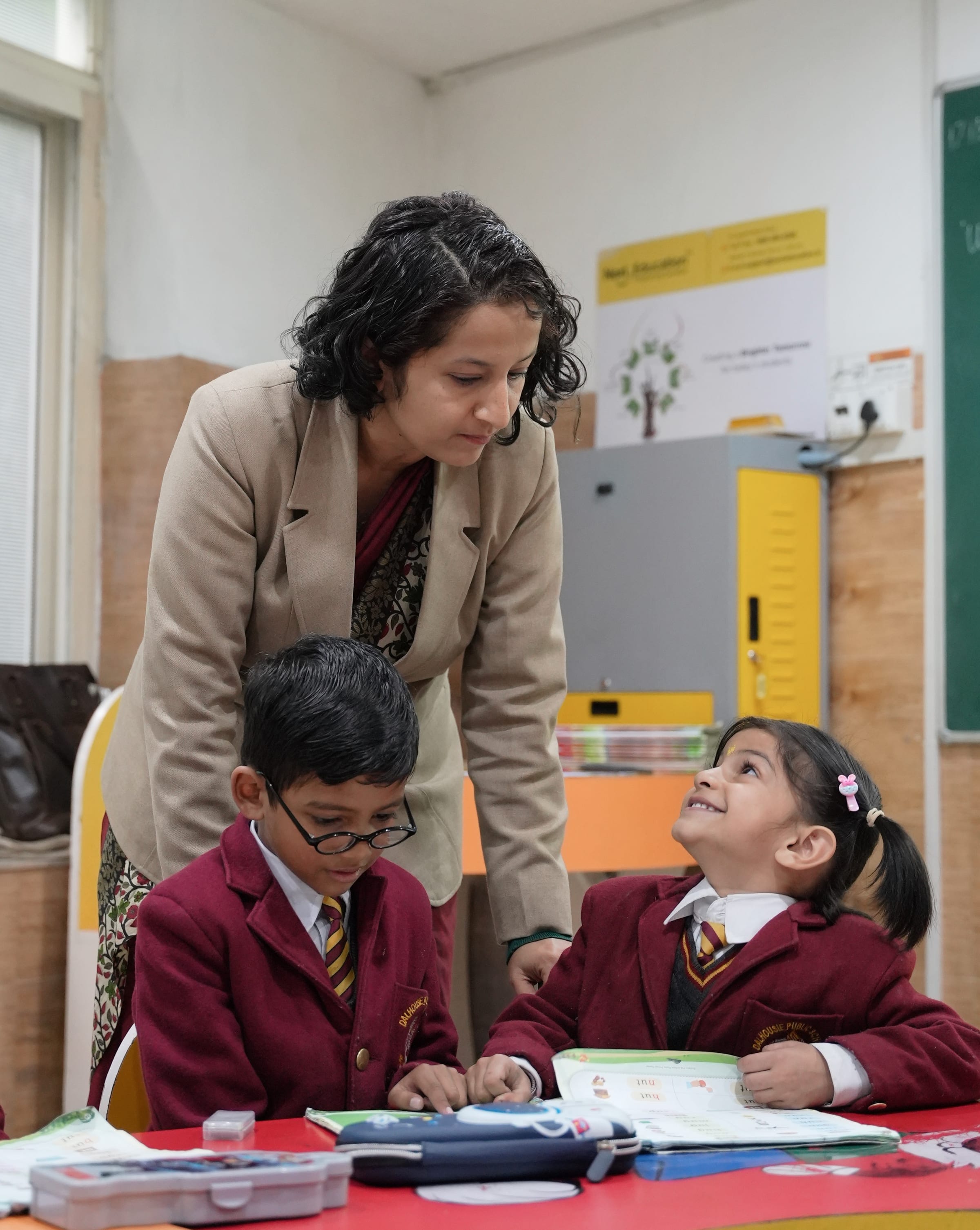 A teacher guiding young students