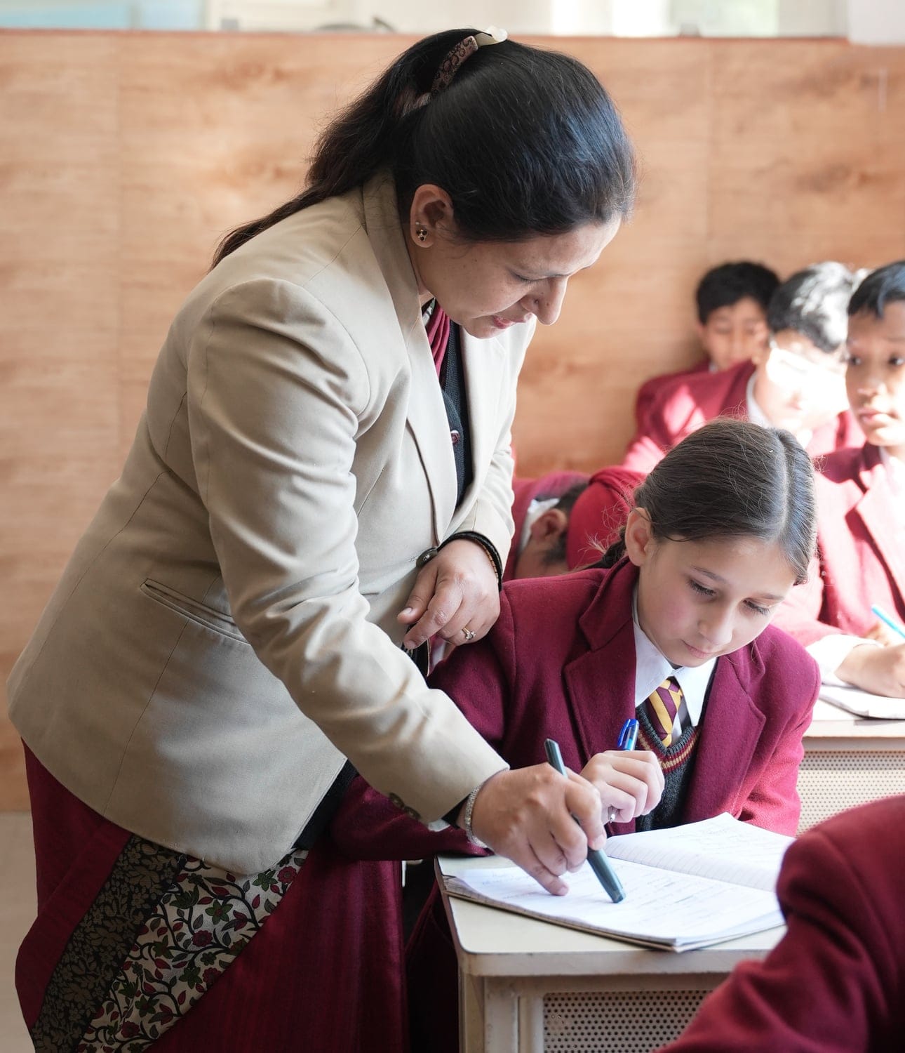 A teacher helping a student with her work