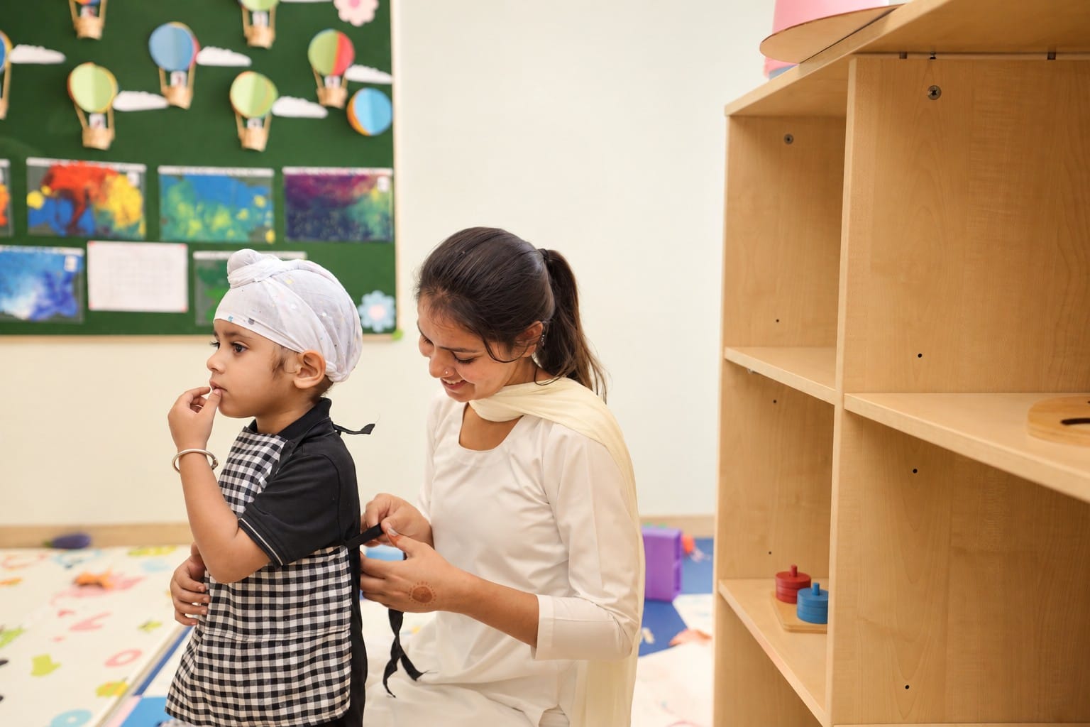 A teacher helping a boy in the classroom